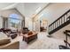 Bright living room with high ceilings, skylights, large windows, and a staircase at 330 N Wagonwheel Trl, Castle Rock, CO 80104