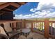 Private balcony with chairs offering stunning views of the surrounding mountains and wooded landscape at 1521 Ski Hill Rd # 8318, Breckenridge, CO 80424