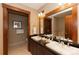 Elegant bathroom boasting double sinks, granite countertops, and wood-trimmed doors at 1521 Ski Hill Rd # 8318, Breckenridge, CO 80424