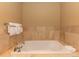 Bathroom area featuring a soaking tub surrounded by decorative tile and wall mounted towel rack at 1521 Ski Hill Rd # 8318, Breckenridge, CO 80424