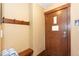Entryway with a wooden door, hooks, bench, and a hanging informational plaque at 1521 Ski Hill Rd # 8318, Breckenridge, CO 80424