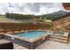 Outdoor hot tub area features scenic views and patio space at 1521 Ski Hill Rd # 8318, Breckenridge, CO 80424