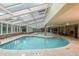 Inviting indoor pool area with skylights, lounge seating, and a serene atmosphere at 1521 Ski Hill Rd # 8318, Breckenridge, CO 80424