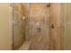 Walk-in shower features decorative tile, glass doors, and a built-in shower seat at 1521 Ski Hill Rd # 8318, Breckenridge, CO 80424