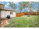 A fenced backyard featuring green grass and a brick fire pit at 3065 W 80Th Ave, Westminster, CO 80030