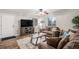 Comfortable living room with a modern television, wood-look floors, and neutral tones at 3065 W 80Th Ave, Westminster, CO 80030