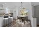 Bright dining area featuring hardwood floors, a modern chandelier, and a window view at 8422 S Upham Way # G60, Littleton, CO 80128