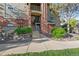 Multi-story home with brick facade, green lawn, landscaped rock feature and manicured bushes at 8422 S Upham Way # G60, Littleton, CO 80128