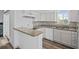 Kitchen featuring modern countertops, appliances, and hardwood floors and open layout at 8422 S Upham Way # G60, Littleton, CO 80128