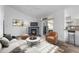 Bright living room featuring a fireplace, balcony access, and hardwood flooring at 8422 S Upham Way # G60, Littleton, CO 80128