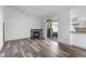 Open living room with fireplace, access to balcony, and hardwood floors at 8422 S Upham Way # G60, Littleton, CO 80128