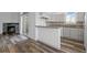 View of living room with fireplace and kitchen with breakfast bar at 8422 S Upham Way # G60, Littleton, CO 80128