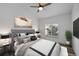 Cozy primary bedroom with large window, plush bedding, and hardwood flooring at 8422 S Upham Way # G60, Littleton, CO 80128