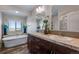 Bright bathroom with double sinks, soaking tub, and a separate shower at 11809 Pass Me By Rd, Strasburg, CO 80136