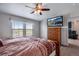 Comfortable bedroom featuring a ceiling fan, window with blinds, and scenic view at 11809 Pass Me By Rd, Strasburg, CO 80136
