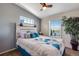 Comfortable bedroom featuring a padded headboard and window with natural light at 11809 Pass Me By Rd, Strasburg, CO 80136