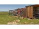 Wooden structure featuring a secure enclosure for chickens at 11809 Pass Me By Rd, Strasburg, CO 80136