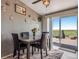 Dining area with a table for four and sliding doors that lead to an outdoor deck at 11809 Pass Me By Rd, Strasburg, CO 80136