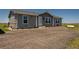 Gray single-story home with a gravel yard and white trim at 11809 Pass Me By Rd, Strasburg, CO 80136