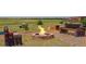 Backyard space featuring outdoor fireplace with stone firepit and backyard space at 11809 Pass Me By Rd, Strasburg, CO 80136