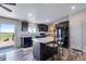 Kitchen featuring stainless steel sink, island with seating, and sliding glass door to the deck at 11809 Pass Me By Rd, Strasburg, CO 80136