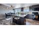 Bright kitchen features an island with bar seating, modern appliances, and lots of natural light at 11809 Pass Me By Rd, Strasburg, CO 80136