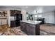 Open kitchen includes stainless appliances, an island, and plenty of cabinet storage at 11809 Pass Me By Rd, Strasburg, CO 80136