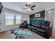 Comfortable living room features a leather sofa, rug, and large window at 11809 Pass Me By Rd, Strasburg, CO 80136