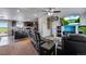 Open-concept living room features a leather sofa and a modern TV at 11809 Pass Me By Rd, Strasburg, CO 80136
