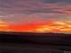 Dramatic sunset with vibrant colors over the horizon, creating a stunning backdrop for this property at 11809 Pass Me By Rd, Strasburg, CO 80136