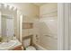 Bathroom with shower/tub combo and white vanity with tile countertop at 15594 E 97Th Ave, Commerce City, CO 80022