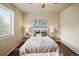 Cozy bedroom features hardwood floors and a soothing neutral color palette at 15594 E 97Th Ave, Commerce City, CO 80022