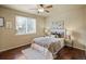Relaxing bedroom with hardwood floors, ceiling fan, and ample natural light at 15594 E 97Th Ave, Commerce City, CO 80022