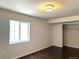 This bright bedroom boasts wood flooring and a window, adjacent to a closet at 15594 E 97Th Ave, Commerce City, CO 80022