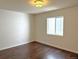 This bright bedroom boasts wood flooring and a large window for natural light at 15594 E 97Th Ave, Commerce City, CO 80022