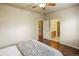 This bedroom features hardwood floors, ceiling fan, and includes both the laundry and ensuite bathroom at 15594 E 97Th Ave, Commerce City, CO 80022