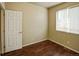 Bedroom features laminate floors, neutral paint and window for natural light at 15594 E 97Th Ave, Commerce City, CO 80022