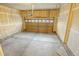 Clean and functional garage space for parking and storage, featuring a paneled garage door and smooth cement floors at 15594 E 97Th Ave, Commerce City, CO 80022