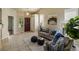 Cozy living room with vaulted ceiling, tile flooring, and stylish neutral decor at 15594 E 97Th Ave, Commerce City, CO 80022