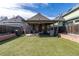 A well-maintained backyard featuring artificial grass, a covered patio, and a nice fence for privacy at 233 W 3Rd Ave, Denver, CO 80223
