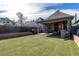 Manicured backyard showing artificial grass and a covered patio, offering a private outdoor space at 233 W 3Rd Ave, Denver, CO 80223