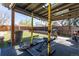 Backyard gym has a workout bench and pull-up bar under a covered patio with a skylight at 233 W 3Rd Ave, Denver, CO 80223