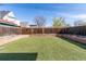 The backyard features an artificial lawn, a wooden fence, and a raised garden bed at 233 W 3Rd Ave, Denver, CO 80223