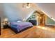 This bedroom has a hardwood floor, ceiling fan, and attic ceilings at 233 W 3Rd Ave, Denver, CO 80223