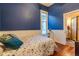 Charming bedroom features blue walls and hardwood floors, creating a cozy retreat at 233 W 3Rd Ave, Denver, CO 80223