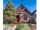 Charming single-Gathering home featuring a red door and decorative brickwork under a sunny sky at 233 W 3Rd Ave, Denver, CO 80223