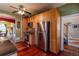 Galley kitchen featuring stainless steel appliances, wooden cabinets, and a ceiling fan at 233 W 3Rd Ave, Denver, CO 80223