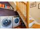Modern laundry room setup with front load washer and dryer and under stairs storage at 233 W 3Rd Ave, Denver, CO 80223