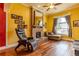 Sun-filled living room with hardwood floors, brick fireplace, and comfortable seating under a ceiling fan at 233 W 3Rd Ave, Denver, CO 80223