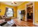 Bright living area features hardwood flooring, large windows, and an adjacent view of a tidy office space at 233 W 3Rd Ave, Denver, CO 80223